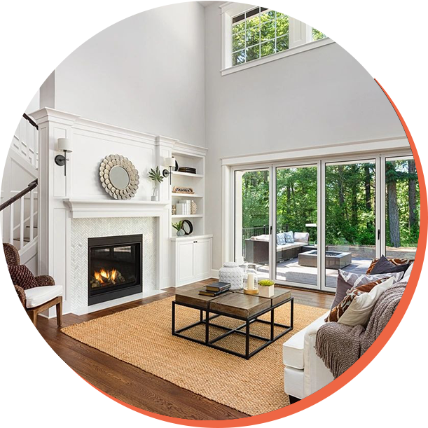 Beautiful living room interior with hardwood floors and fireplace in new luxury home with sliding glass doors and vaulted ceiling