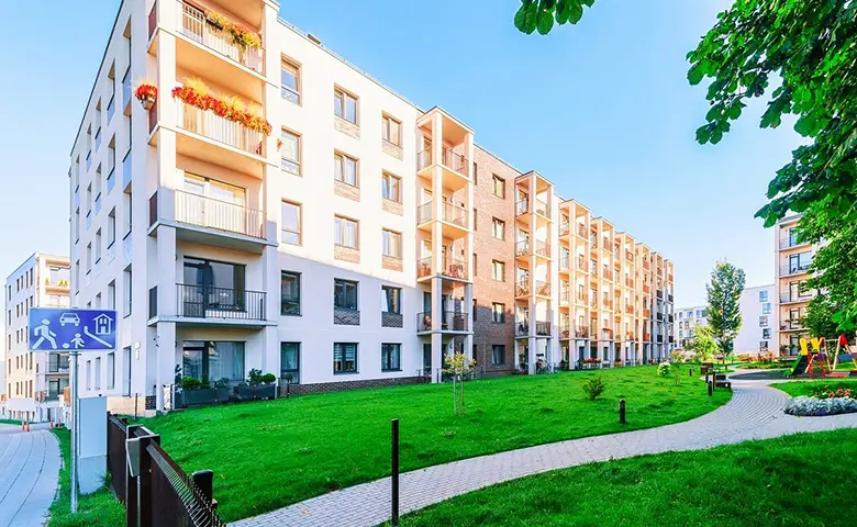 Complex of new apartment building with children playground as other outdoor facilities